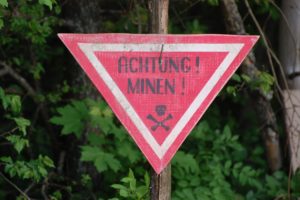 bigstock--Achtung-minen-sign-WW-reen-29171390